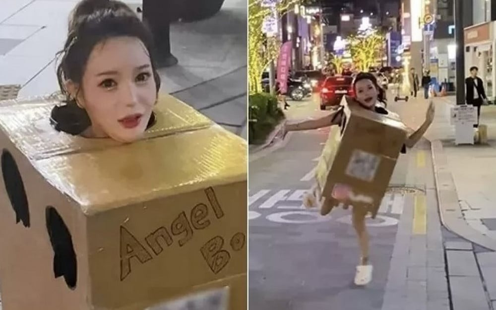 Ah In mặc hộp carton với dòng chữ Angel Box Girl trên phố Apgujeong